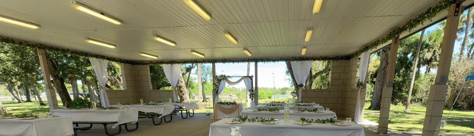 Wide view of the open-air wedding pavilion and reception design