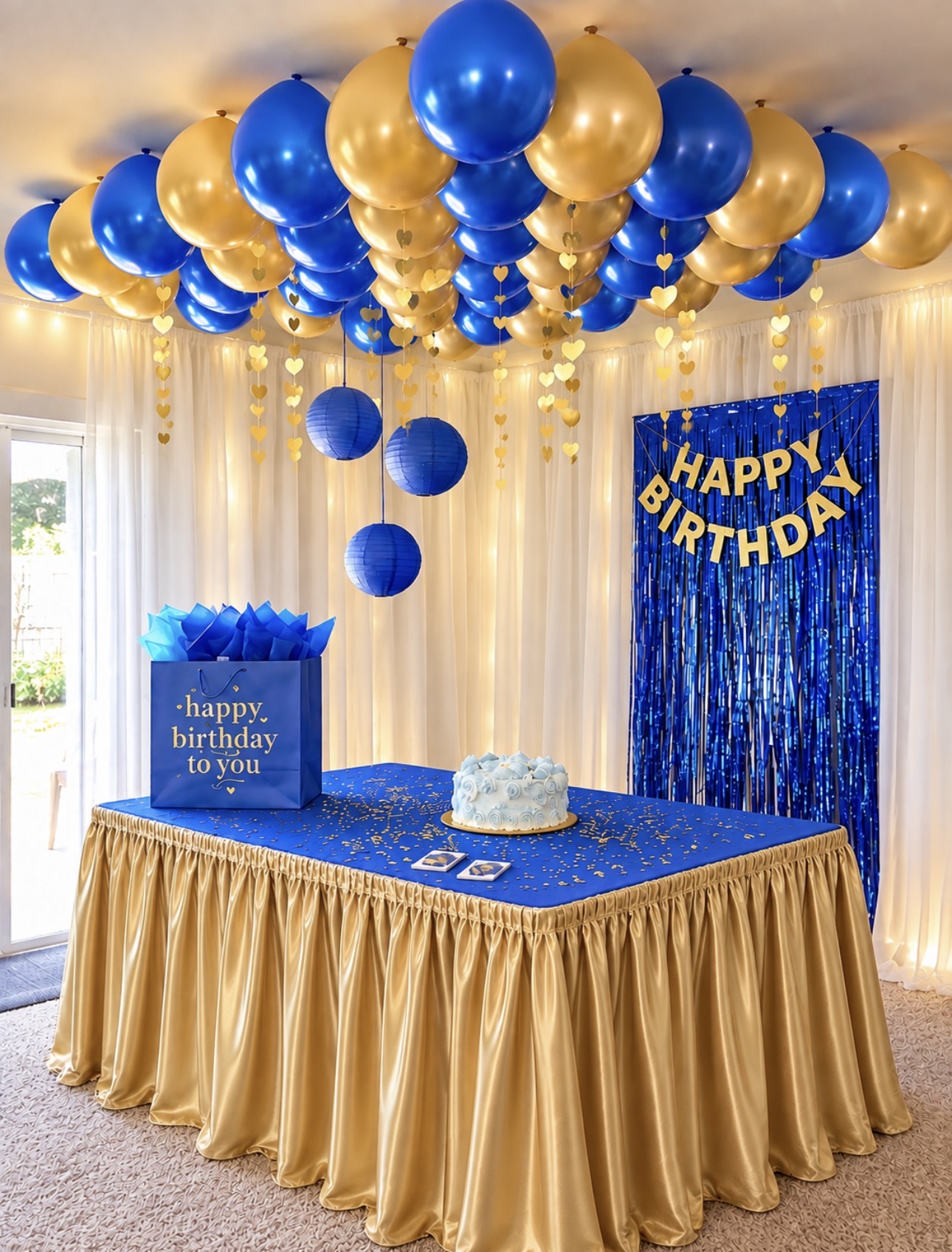 Royal blue and gold birthday display with hanging balloons