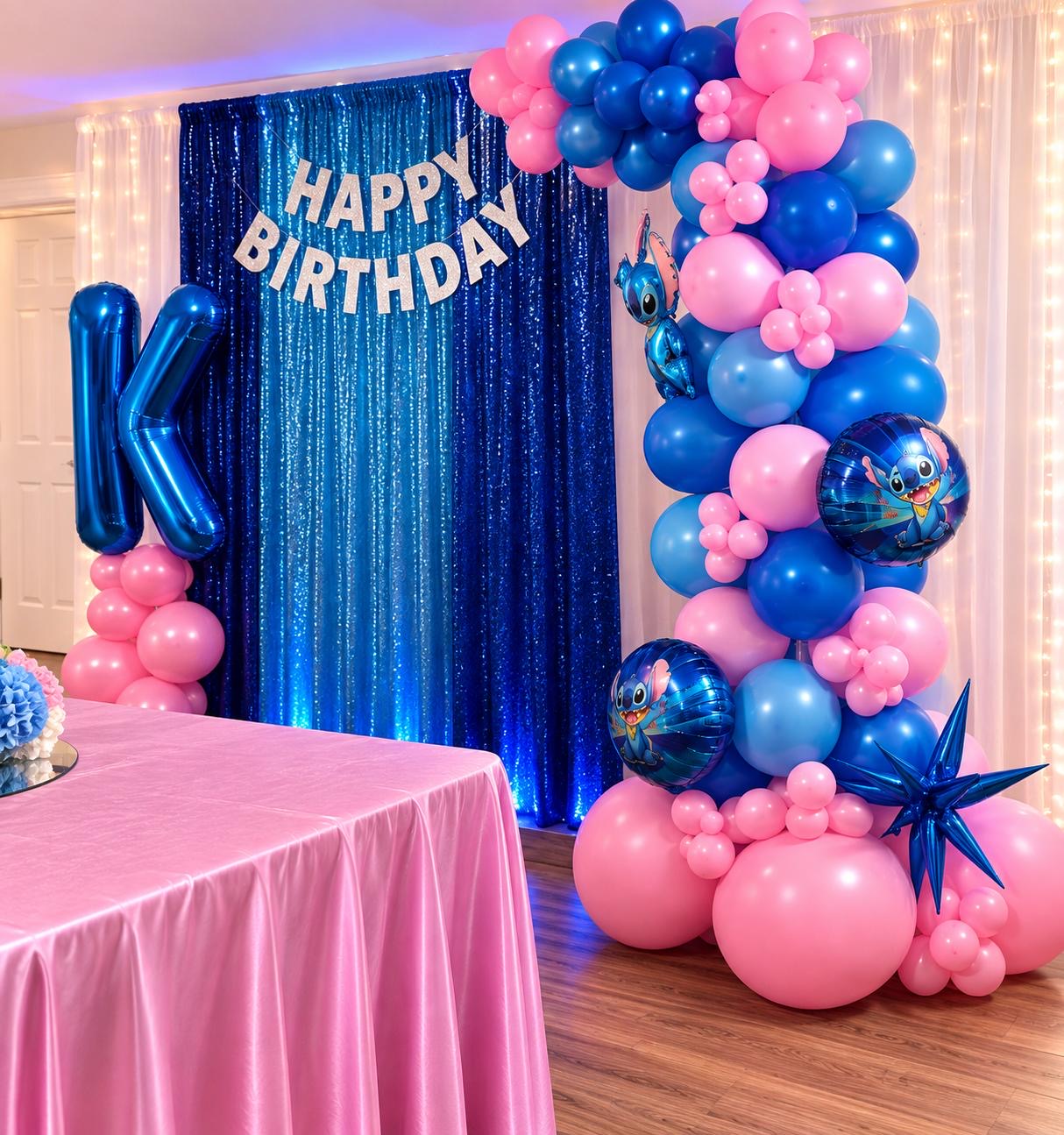 Blue and pink birthday backdrop with balloon garland and illuminated letter
