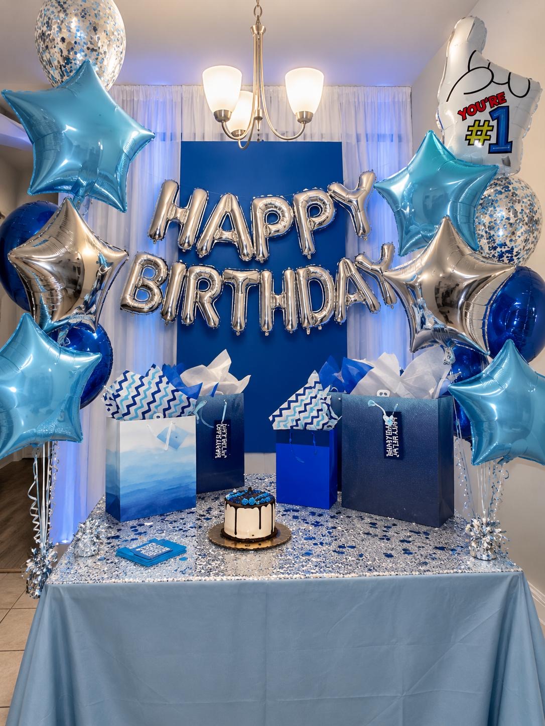 Blue and silver birthday table with metallic star balloons