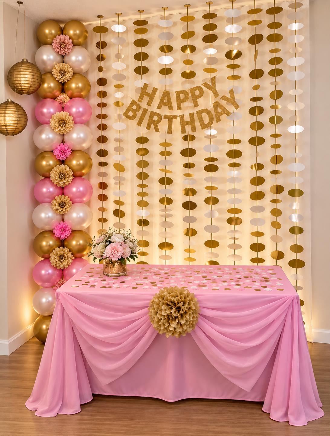 Pink and gold birthday table with balloons and shimmering wall accents