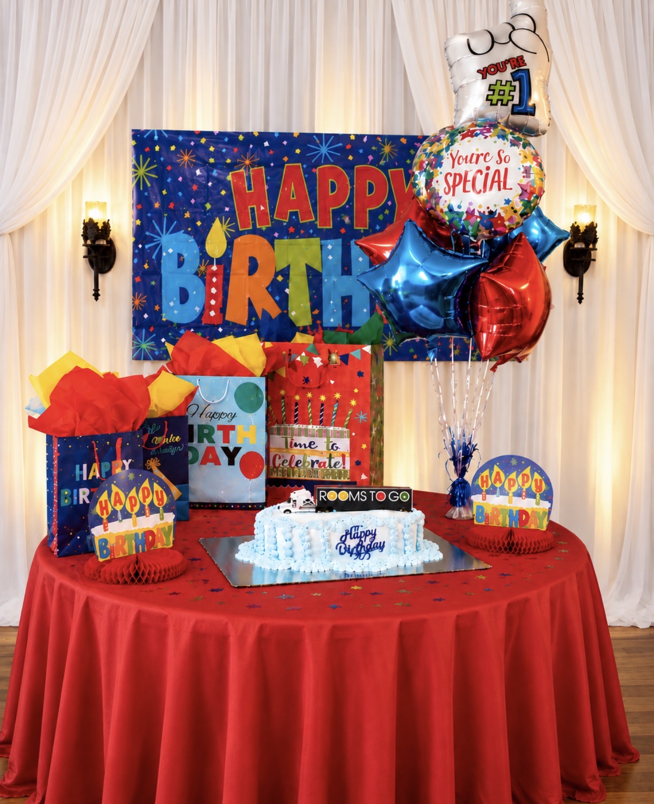 Colorful superhero birthday cake and gift table